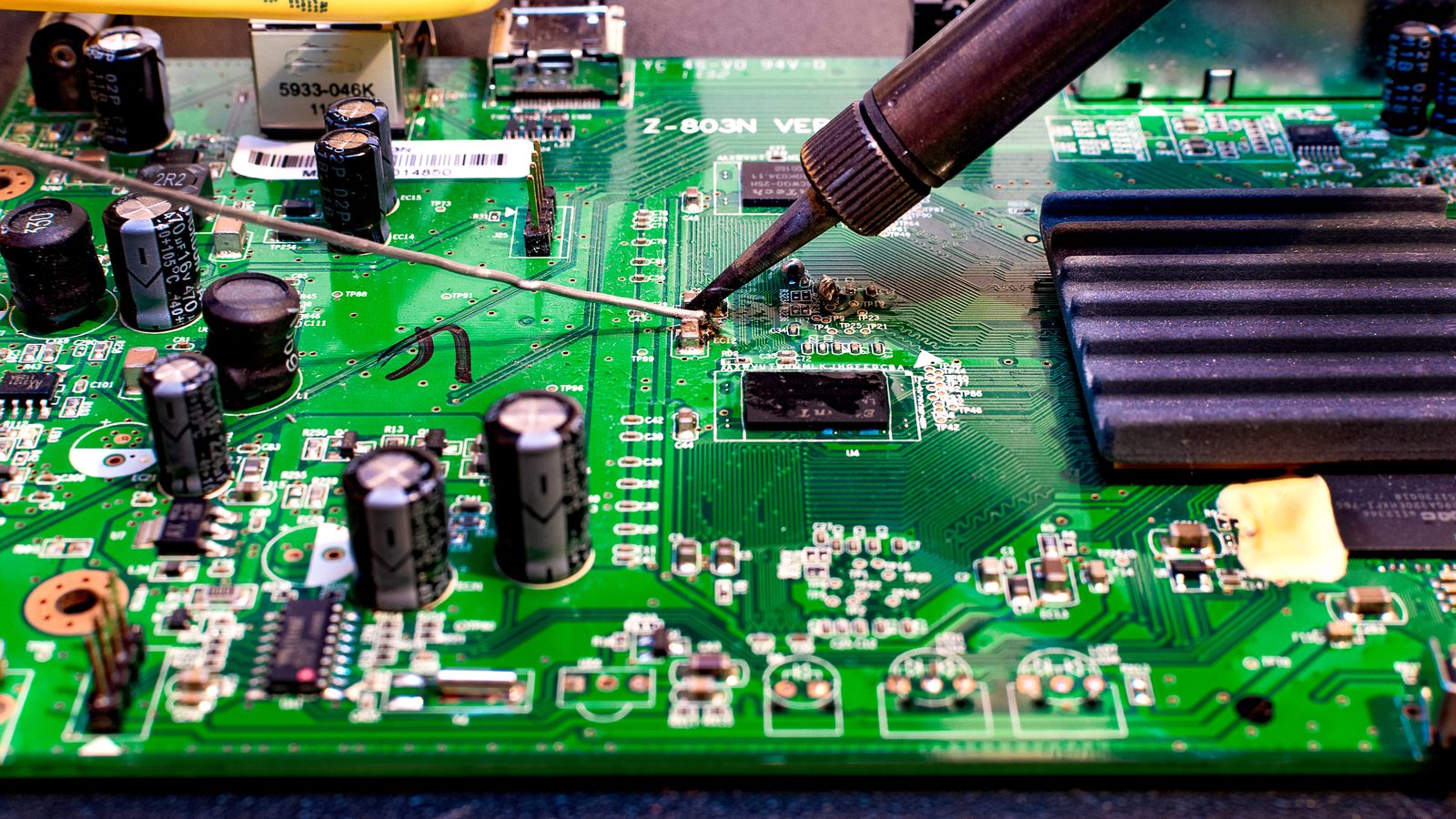Same-day TV repair technician working on a television circuit board